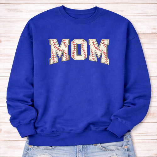 Blue sweatshirt with 'MOM' printed on it against a wooden background